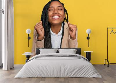 African american woman wearing business jacket excited for success with arms raised and eyes closed celebrating victory smiling. winner concept. Wall mural