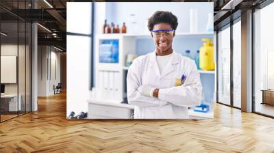 African american woman wearing scientist uniform standing with arms crossed gesture at laboratory Wall mural