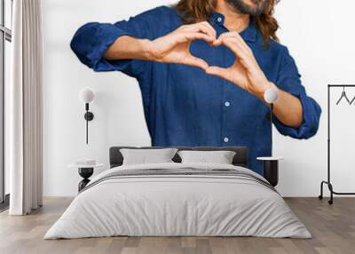 Attractive man with long hair and beard wearing casual clothes smiling in love doing heart symbol shape with hands. romantic concept. Wall mural