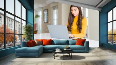 Beauitul young woman working using computer laptop concentrated Wall mural