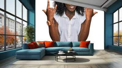 Beautiful african young woman wearing casual clothes shouting with crazy expression doing rock symbol with hands up. music star. heavy concept. Wall mural