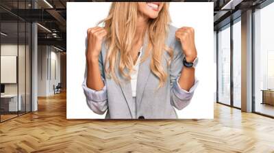 Beautiful blonde young woman wearing business clothes very happy and excited doing winner gesture with arms raised, smiling and screaming for success. celebration concept. Wall mural