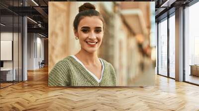 Beautiful brunette woman smiling happy and confident outdoors at the city on a sunny day of autumn Wall mural