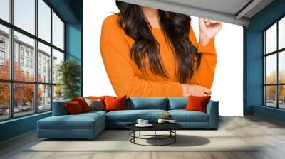 Beautiful brunette young woman wearing casual orange sweater smiling happy pointing with hand and finger to the side Wall mural