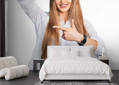 Beautiful caucasian woman wearing casual white shirt smiling making frame with hands and fingers with happy face. creativity and photography concept. Wall mural