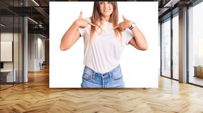 Beautiful caucasian woman wearing casual white tshirt looking confident with smile on face, pointing oneself with fingers proud and happy. Wall mural