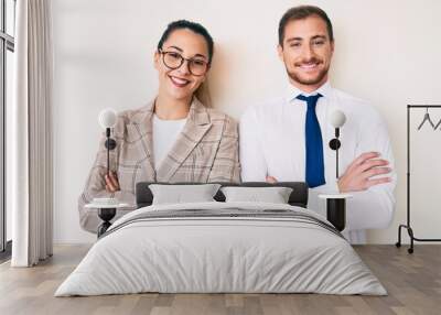 Beautiful couple wearing business clothes happy face smiling with crossed arms looking at the camera. positive person. Wall mural