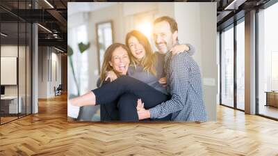 Beautiful family together. Mother, father and daughter smiling and hugging with love at home. Wall mural