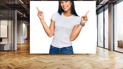 Beautiful hispanic woman wearing casual white tshirt smiling confident pointing with fingers to different directions. copy space for advertisement Wall mural