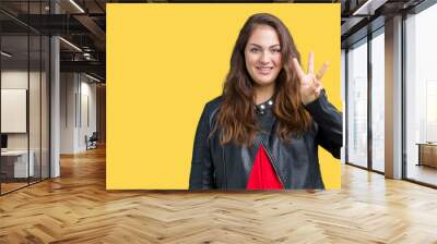 Beautiful plus size young woman wearing a fashion leather jacket over isolated background showing and pointing up with fingers number three while smiling confident and happy. Wall mural