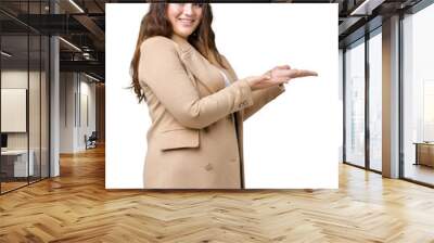 Beautiful plus size young woman wearing winter coat over isolated background Pointing to the side with hand and open palm, presenting ad smiling happy and confident Wall mural