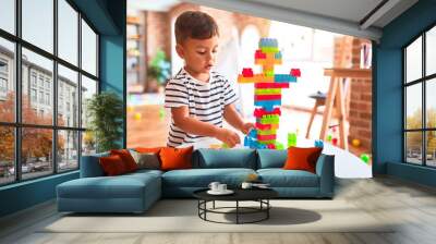 Beautiful toddler boy playing with construction blocks at kindergarten Wall mural