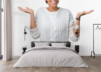 Beautiful young african american woman wearing sweater over isolated background Smiling showing both hands open palms, presenting and advertising comparison and balance Wall mural