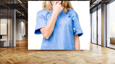 Beautiful young doctor woman wearing medical uniform over isolated background looking confident at the camera with smile with crossed arms and hand raised on chin. Thinking positive. Wall mural