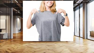 Beautiful young woman wearing oversize casual t-shirt over isolated background looking confident with smile on face, pointing oneself with fingers proud and happy. Wall mural