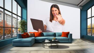 Beautiful young woman working using computer laptop over white background pointing to you and the camera with fingers, smiling positive and cheerful Wall mural