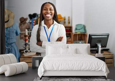 Black woman with braids working as manager at retail boutique happy face smiling with crossed arms looking at the camera. positive person. Wall mural