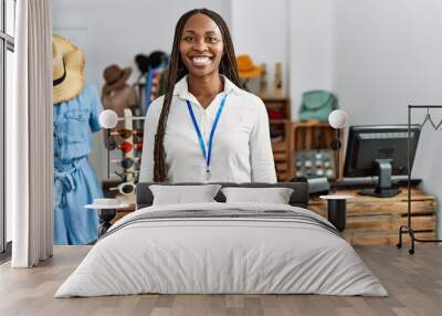 Black woman with braids working as manager at retail boutique with a happy and cool smile on face. lucky person. Wall mural