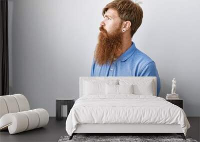 Caucasian man with long beard standing over isolated background looking to side, relax profile pose with natural face with confident smile. Wall mural