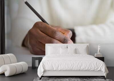 Close up of african man writing a note on a paper Wall mural