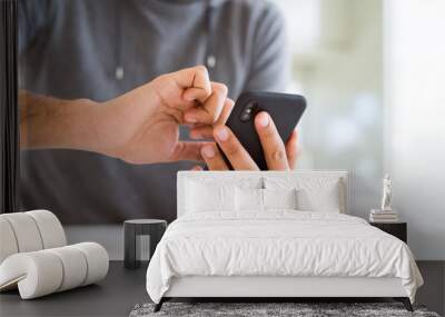 Close up of man using smartphone Wall mural