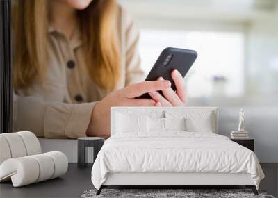 Close up of woman using smartphone Wall mural