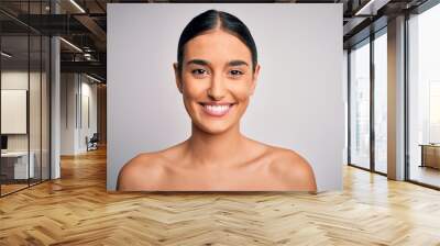 Close up of young beautiful woman with clear and pure skin. Perfect and clean skincare wearing natural makeup. Smiling happy looking fresh and healthy. Wall mural