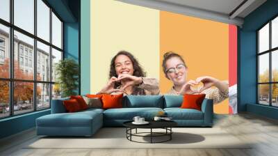 Collage of a group of people isolated over colorful background smiling in love showing heart symbol and shape with hands. Romantic concept. Wall mural