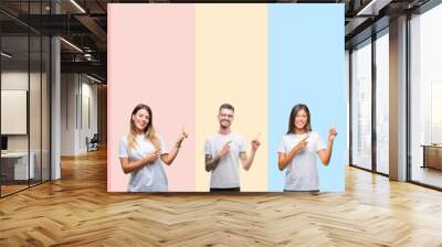 Collage of different ethnics young people wearing white t-shirt over colorful isolated background smiling and looking at the camera pointing with two hands and fingers to the side. Wall mural