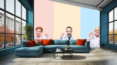 collage of professional doctors over colorful stripes isolated background pointing finger up with su Wall mural