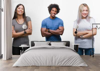 Composition of african american, hispanic and caucasian group of people over isolated white background happy face smiling with crossed arms looking at the camera. Positive person. Wall mural