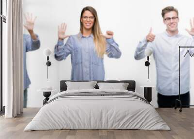 Composition of african american, hispanic and caucasian group of people over isolated white background showing and pointing up with fingers number six while smiling confident and happy. Wall mural