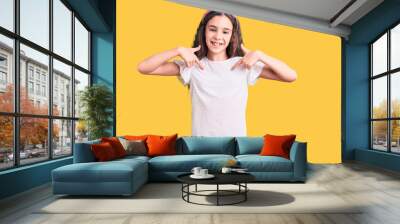 Cute hispanic child girl wearing casual white tshirt looking confident with smile on face, pointing oneself with fingers proud and happy. Wall mural