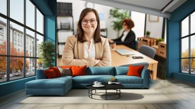 Down syndrome girl working at inclusive teamwork. Group of two women working at the office Wall mural