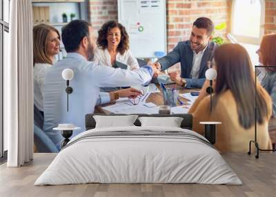 group of business workers smiling happy and confident. working together with smile on face shaking h Wall mural