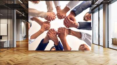 Group of business workers standing with hands together at the office Wall mural