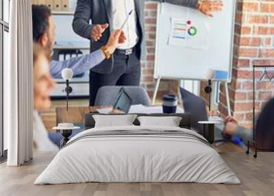 Group of business workers working together in a meeting. One of them making presentation to colleagues at the office Wall mural