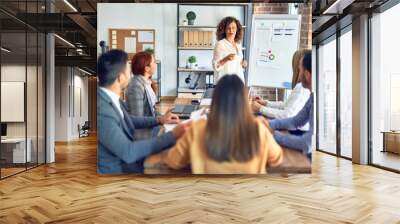 Group of business workers working together in a meeting. One of them making presentation to colleagues at the office Wall mural