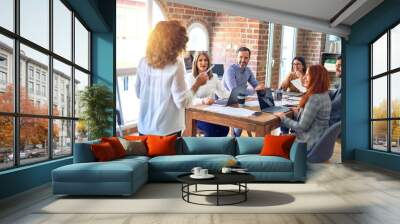 Group of business workers working together in a meeting. One of them making presentation to colleagues at the office Wall mural