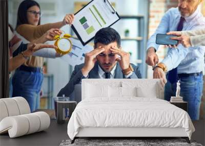 Group of business workers working together. Partners stressing one of them at the office Wall mural