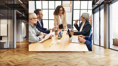 Group of middle age business workers listening boss speech at the office Wall mural