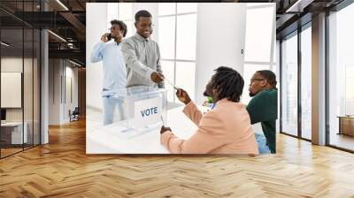 Group of young african american voter people putting vote in ballot standing at electoral center. Wall mural