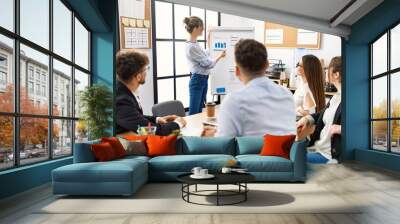 Group of young business workers listening boss conference during meeting at the office. Wall mural