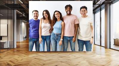 Group of young people standing together over isolated background sticking tongue out happy with funny expression. emotion concept. Wall mural