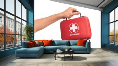 Hand of caucasian young man holding first aid kit over isolated white background Wall mural