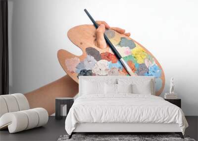 Hand of caucasian young man holding paintbrush and palette with colors over isolated white background Wall mural