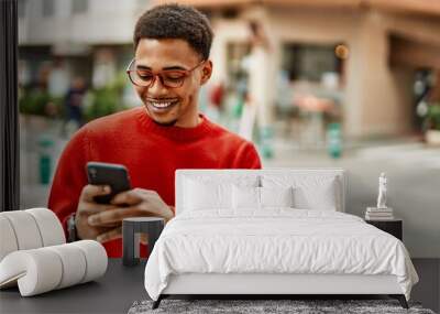 Handsome african american man outdoors using smartphone typing a message Wall mural