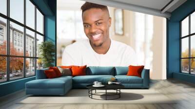 Handsome african young man smiling cheerful with a big smile on face Wall mural