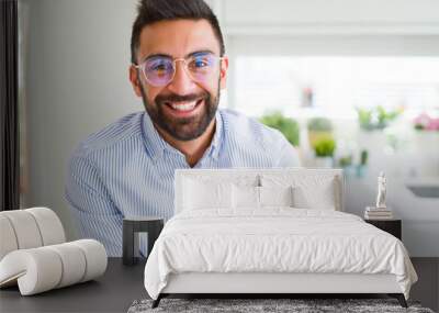 Handsome business man wearing glasses and smiling cheerful with confident smile on face Wall mural