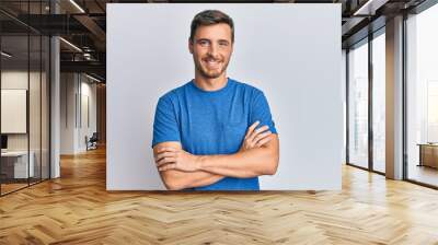 Handsome caucasian man wearing casual clothes happy face smiling with crossed arms looking at the camera. positive person. Wall mural